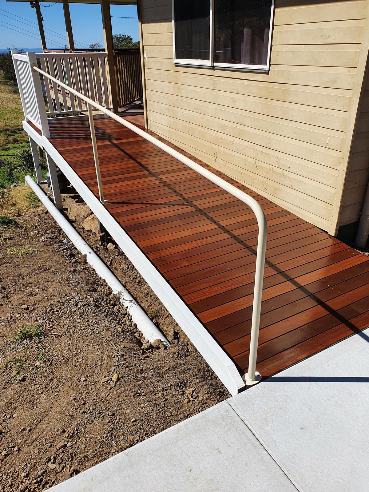 wooden ramp with guard rail to home